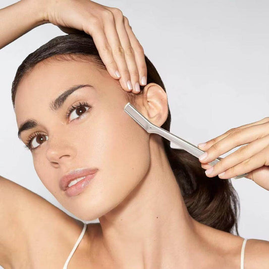 Woman using an eyebrow and facial hair trimmer for precise grooming and shaping.